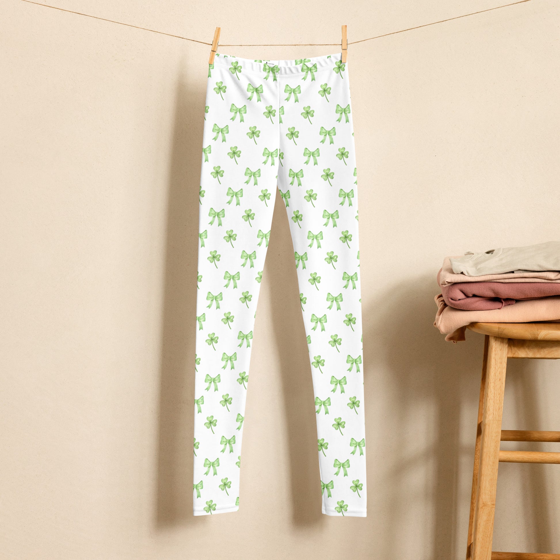 Image: St Patricks Day Leggings for toddlers, girls, tween and women. These white coquette yoga pants feature a dainty pattern of shamrocks and bows, by jaecrece