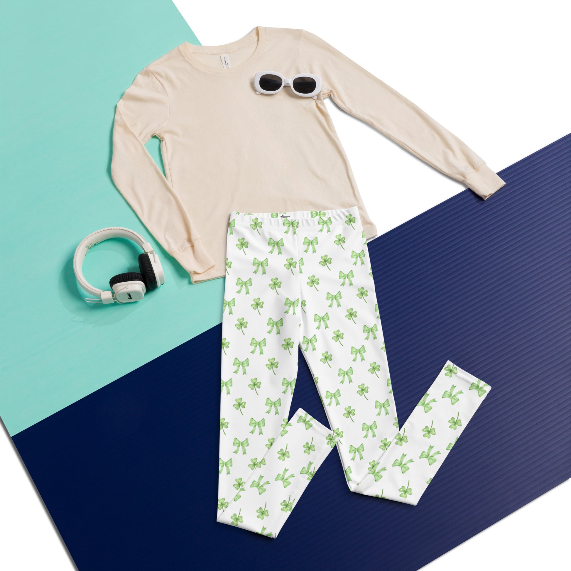 Image: St Patricks Day Leggings for toddlers, girls, tween and women. These white coquette yoga pants feature a dainty pattern of shamrocks and bows, by jaecrece