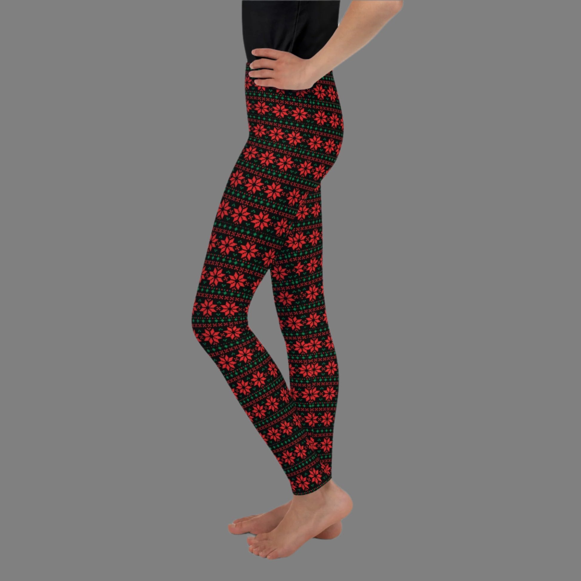 Christmas Poinsettia Toddler Leggings. Sizes 8, 10, 12, 14, 16, 18 and 20. Black leggings with an ugly sweater red and green poinsettia holiday pattern, by jaecrece