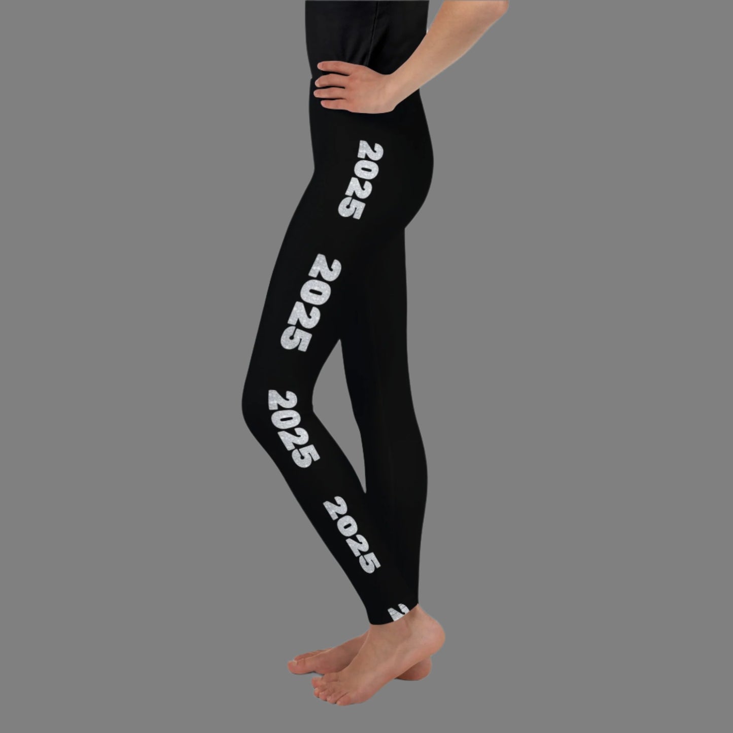 2025 Leggings for Happy New Year Party Celebration or a gift for graduating class of 2025. Black yoga pants have large repeating silver 2025 running down the outside of each leg. Tights are available in youth, tween, teen sizes 8-20, by jaecrece