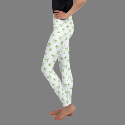 Image: St Patricks Day Leggings for toddlers, girls, tween and women. These white coquette yoga pants feature a dainty pattern of shamrocks and bows, by jaecrece