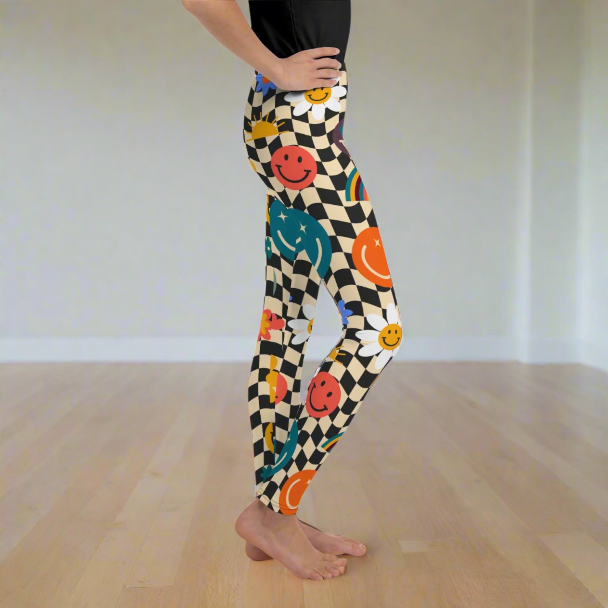 Image: Retro Checkerboard Girls Leggings, in size 8-20. These yoga pants feature a black and khaki vintage check pattern with smiley faces, daisies, rainbows and suns. These vintage tights make a great birthday present, birthday gift, and are great for back to school, by jaecrece