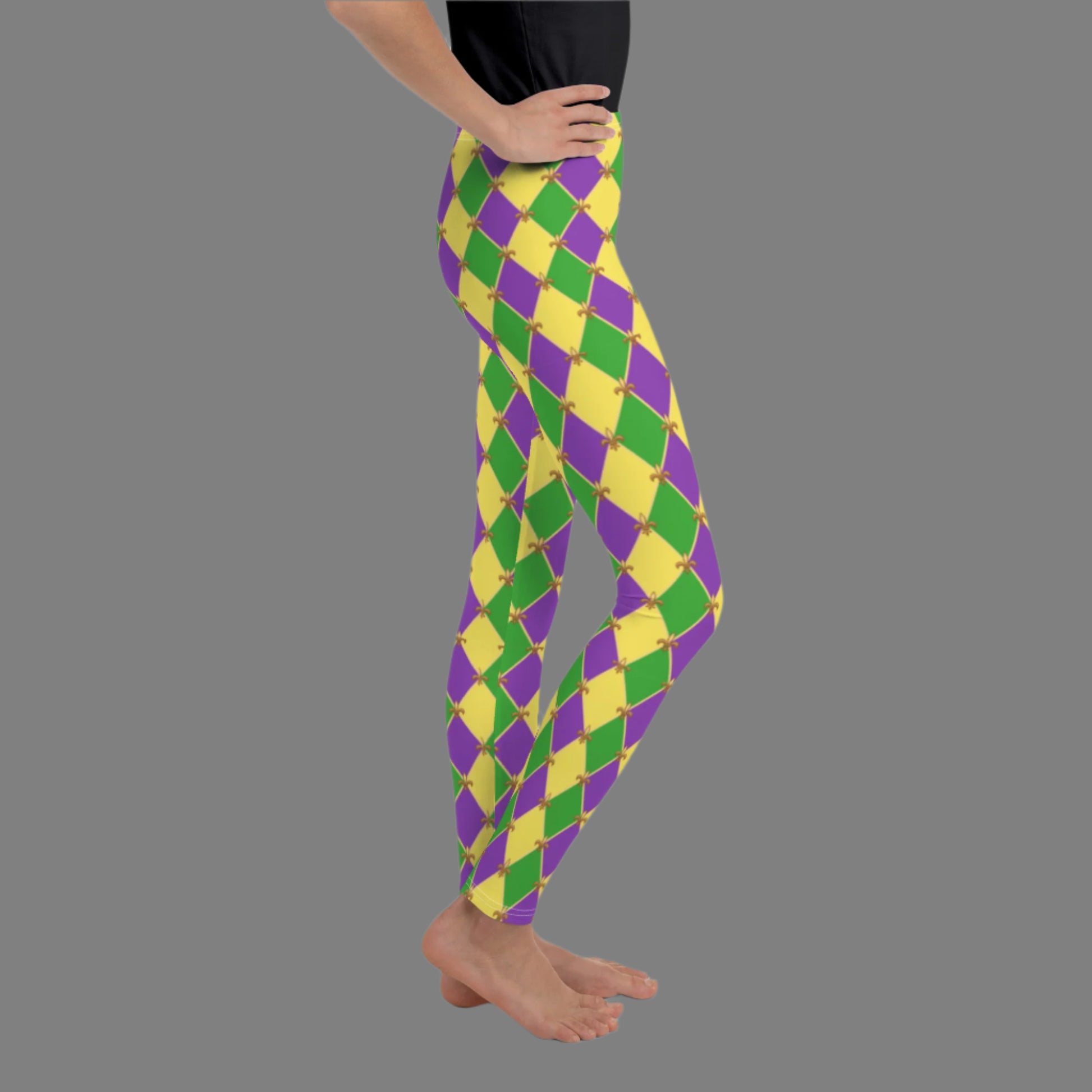 image: Youth girls harlequin diamond or checkerboard pattern leggings in purple, green and gold, with a repeating Fleur de Lis pattern, by jaecrece
Mardi Gras Leggings, Fat Tuesday Tights, teen Parade Outfit, Yoga Workout Pants, Mommy Me Match, New Orleans Tween Girl NOLA Costume