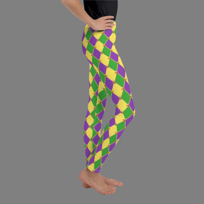 image: Youth girls harlequin diamond or checkerboard pattern leggings in purple, green and gold, with a repeating Fleur de Lis pattern, by jaecrece
Mardi Gras Leggings, Fat Tuesday Tights, teen Parade Outfit, Yoga Workout Pants, Mommy Me Match, New Orleans Tween Girl NOLA Costume