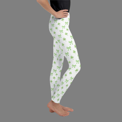 Image: St Patricks Day Leggings for toddlers, girls, tween and women. These white coquette yoga pants feature a dainty pattern of shamrocks and bows, by jaecrece