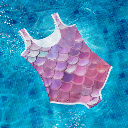 Make a splash with our Mermaid Youth Girls Swimsuit! Available in sizes 8-20, this one piece features vibrant mermaid scales in shades of pink, purple, blue, and white. Your little mermaid will love the playful design while staying comfortable and stylish at the beach or pool.