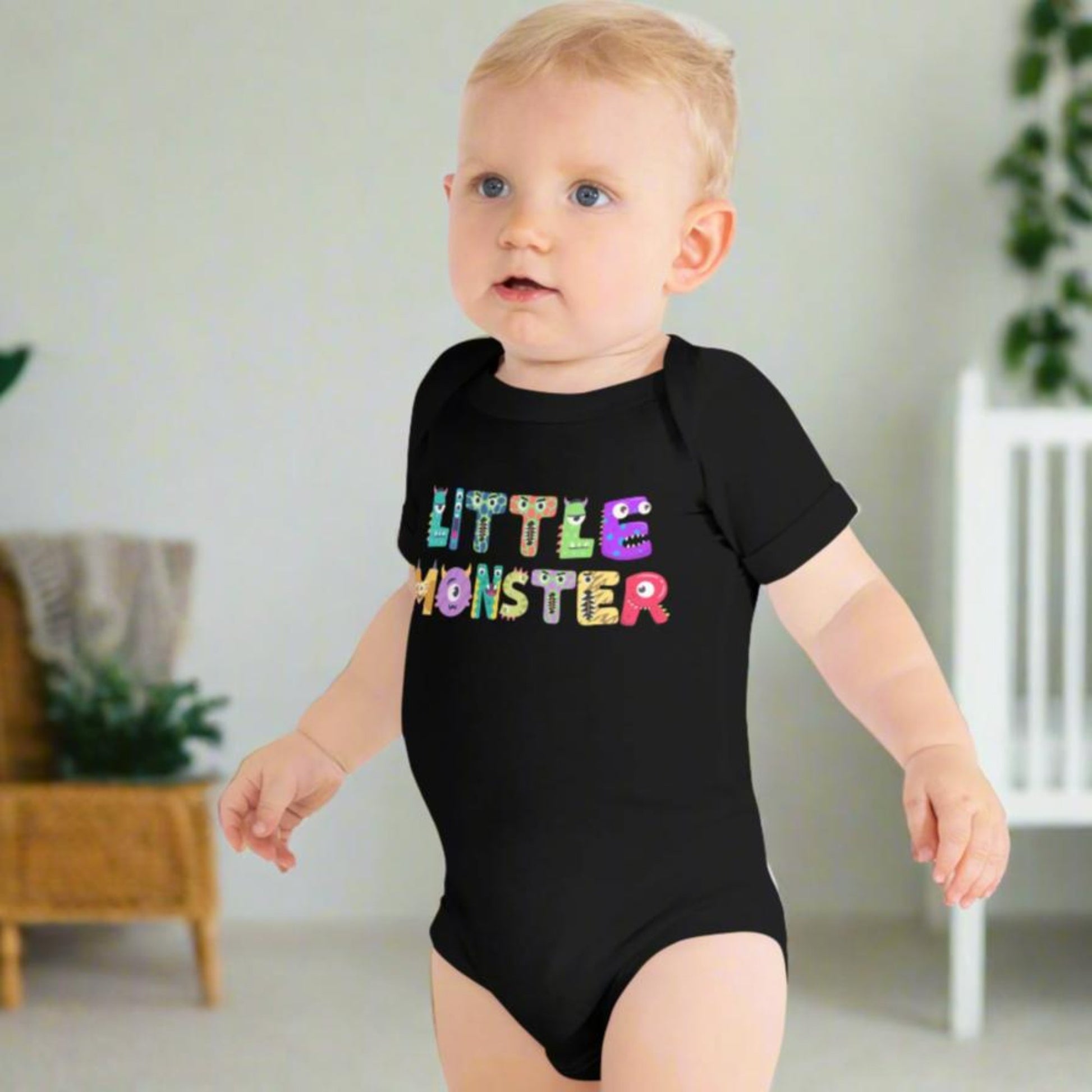 Baby onesie available in black or white. Features the words Little Monster, and each letter is in the shape of a cute cartoon monster, by jaecrece