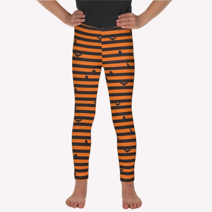 Little Girl wearing black and orange Halloween striped leggings featuring bats, cats, and ghosts for a cute spooky season outfit