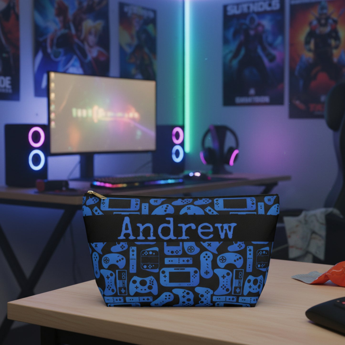 Pouch with blue gaming controller pattern and 'Andrew' text on a black background