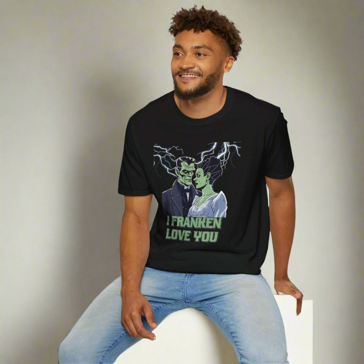 Cute spooky tee showing romantic Frankenstein and his bride under lightning, “I Franken Love You.” Black unisex Gildan 64000 shirt, sizes S-5XL. Perfect for Halloween couples, fun spooky date nights, monster-themed parties, trick-or-treat adventures, or as a romantic Halloween gift. Great for gothic Halloween outfits, playful pun shirts, and adults who love Halloween humor and festive casual wear.