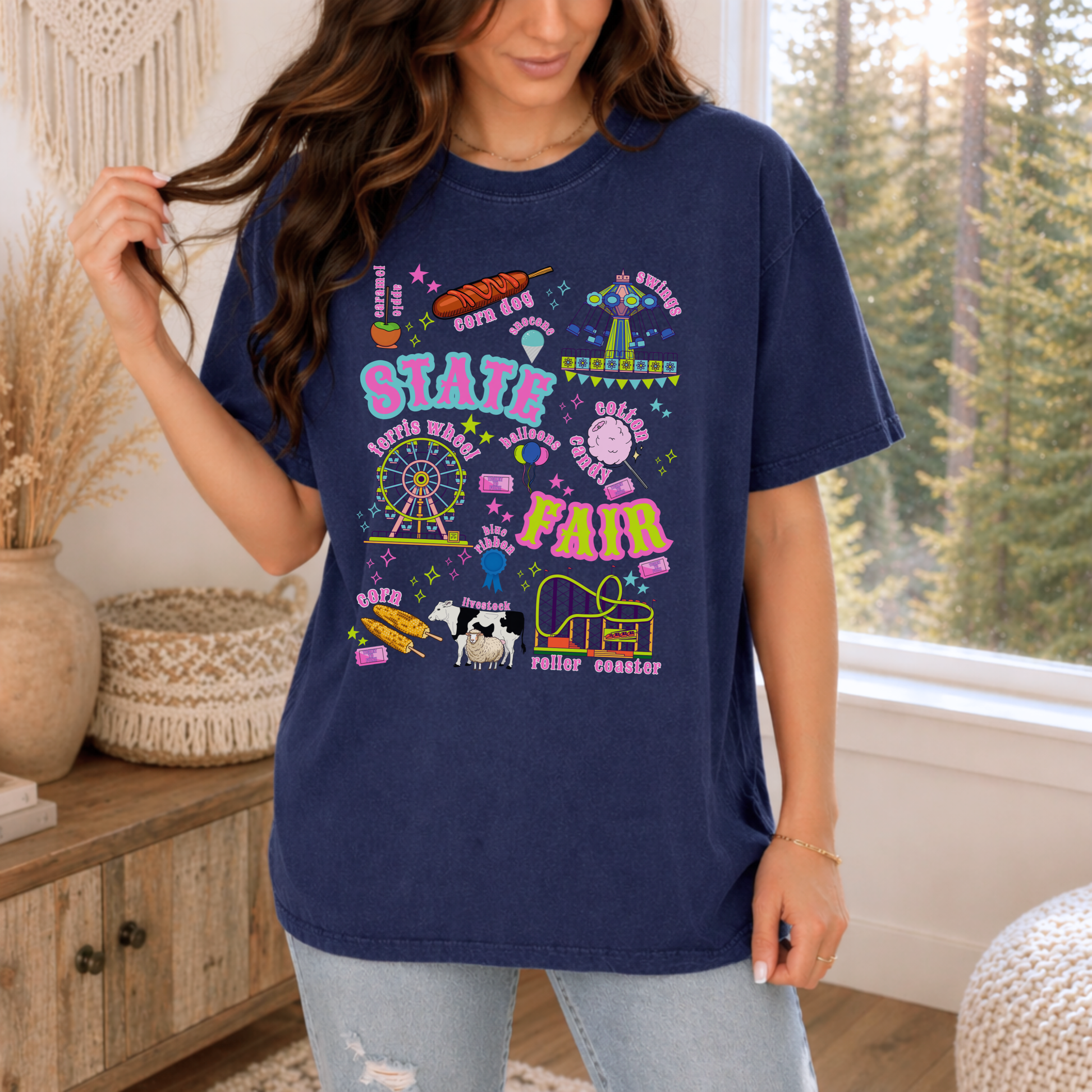 Navy retro fair shirt artwork combines classic carnival and county fair imagery with playful lettering, featuring a Ferris wheel, roller coaster, swing ride, cotton candy, corn dogs, funnel cake, balloons, livestock, prize ribbon and tickets in bright pink, aqua, lime, orange and purple at local fairgrounds.