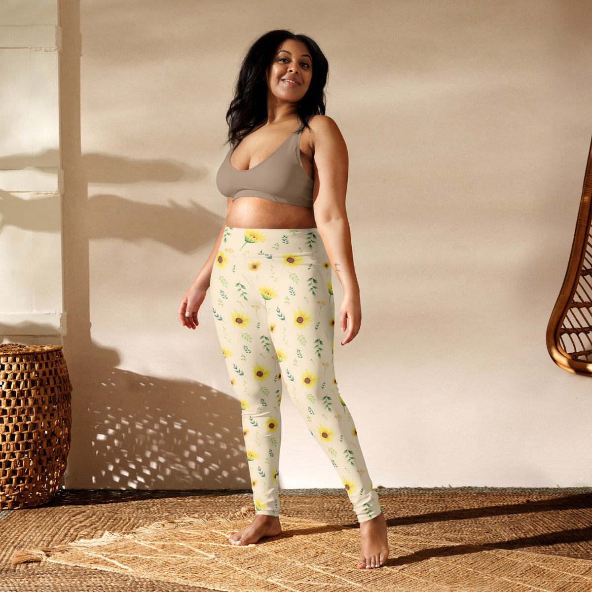 Women's leggings with a soft cottagecore inspired sunflower pattern featuring yellow flowers, green leaves, and delicate botanical sprigs on a creamy neutral background. The gentle color palette and illustrated floral design create a relaxed garden aesthetic that works well beyond activewear. Style them with a simple top for everyday errands, outdoor activities, travel, farmers markets, or a casual spring and summer outfit.