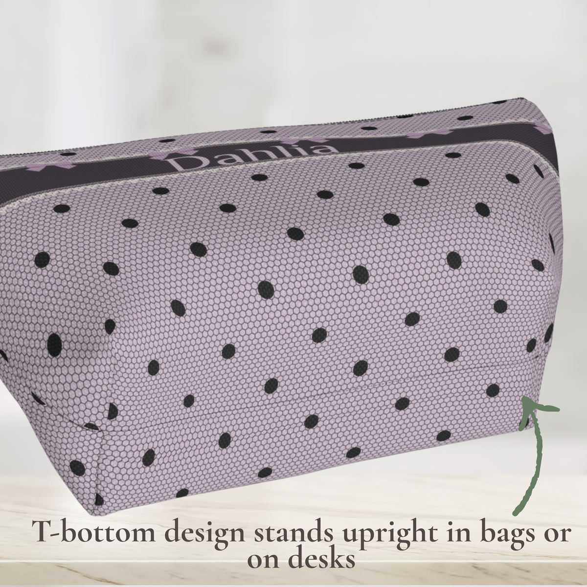Gothic coquette canvas zipper pouch in lavender and black with a delicate bow and polka dot design, lace inspired accents and personalized lettering. Use it as a makeup bag, skincare bag or toiletry bag for women and girls. Its dark romance aesthetic makes it a stylish personalized accessory for travel, sleepovers and everyday organization.