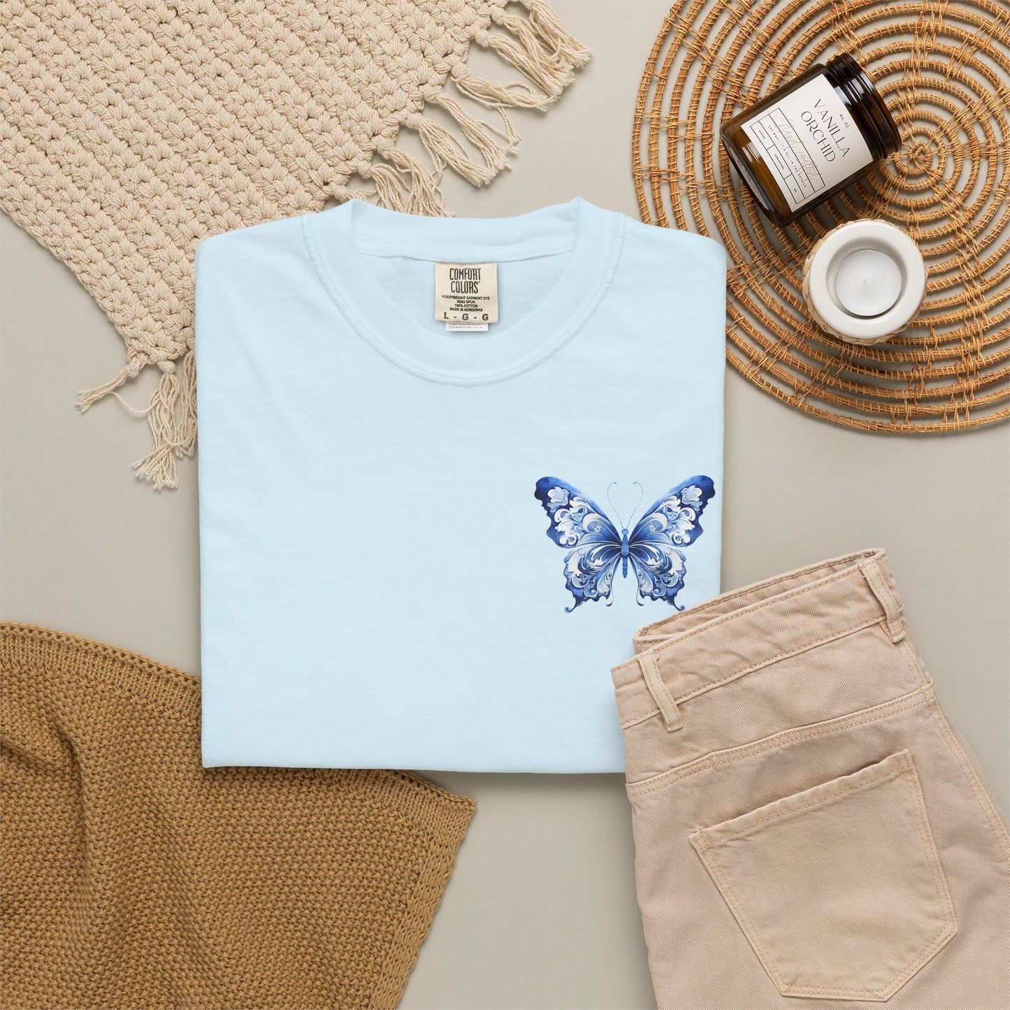 Comfort Colors women’s tee with elegant blue toile butterfly artwork on the left chest. Soft relaxed cotton shirt sold in five colors and sizes S through 4XL. Chinoiserie inspired butterfly design adds a subtle feminine statement while keeping a minimal clean look. Ideal for boutique shoppers who love coastal grandmother style, French aesthetic clothing, vintage botanical prints, comfy basics, and stylish everyday wardrobes.