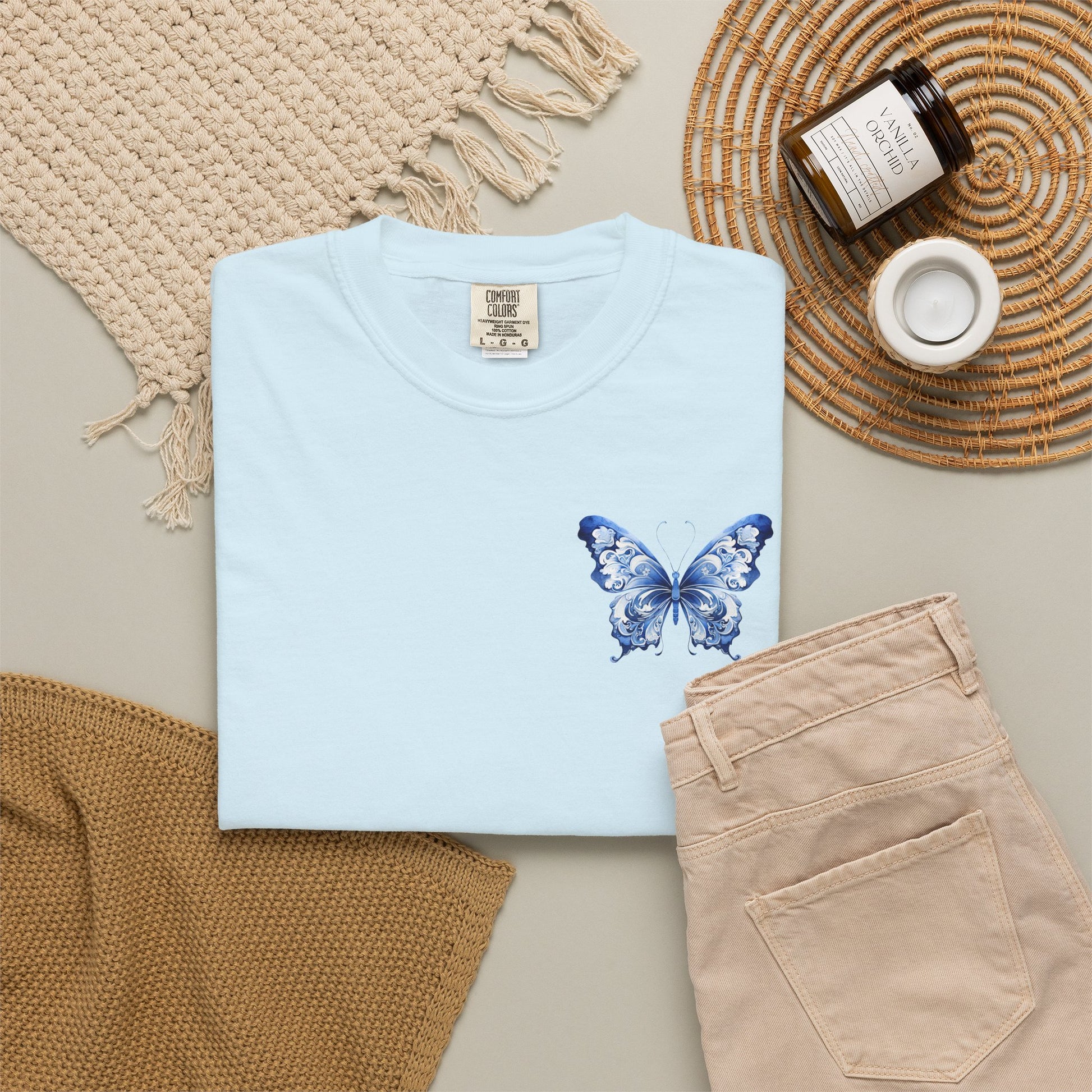 Comfort Colors women’s tee with elegant blue toile butterfly artwork on the left chest. Soft relaxed cotton shirt sold in five colors and sizes S through 4XL. Chinoiserie inspired butterfly design adds a subtle feminine statement while keeping a minimal clean look. Ideal for boutique shoppers who love coastal grandmother style, French aesthetic clothing, vintage botanical prints, comfy basics, and stylish everyday wardrobes.