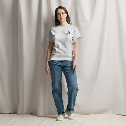 Woman wearing ash grey embroidered cherry hearts t shirt featuring red cherry heart embroidery on the front. Designed on a relaxed fit Gildan S5000 tee, this neutral everyday top is perfect for casual wear, lounging, and errands. Matching girls shirt available separately for mommy and me outfits, creating coordinated family style with a soft modern aesthetic.