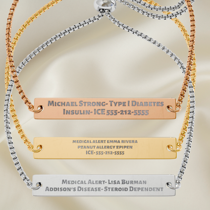 Three personalized medical ID bracelets displayed on a soft beige satin background. The bracelets feature gold, silver, and rose gold chains with flat rectangular nameplates engraved with medical information.