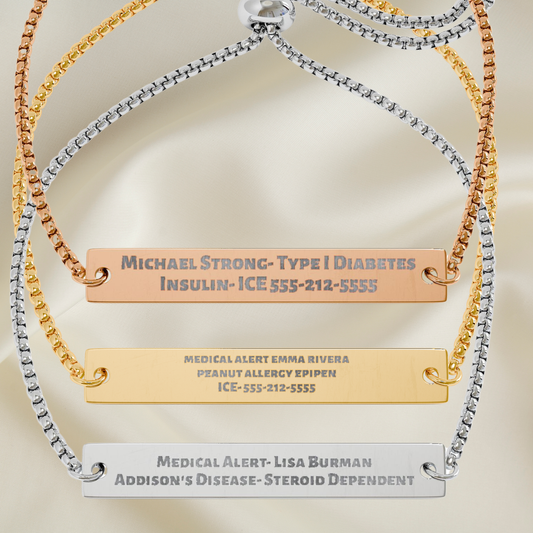 Three personalized medical ID bracelets displayed on a soft beige satin background. The bracelets feature gold, silver, and rose gold chains with flat rectangular nameplates engraved with medical information.