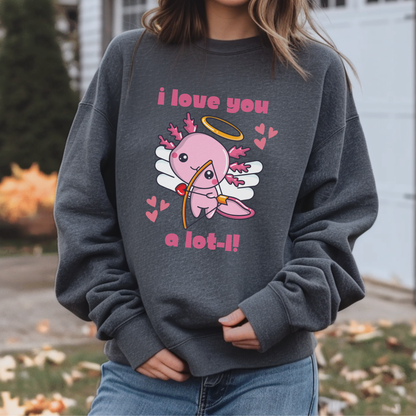 A person wearing a dark gray crewneck sweatshirt with a pink angel graphic and the text 'i love you a lot-!!' on the front, paired with blue jeans in an outdoor setting. Cute axolotl lover sweatshirt with a playful Valentine’s Day cupid design and romantic animal pun. Cozy unisex crewneck perfect for Valentine celebrations, Galentine’s gatherings, animal lover gifts, casual outfits, and coordinated family Valentine photos.