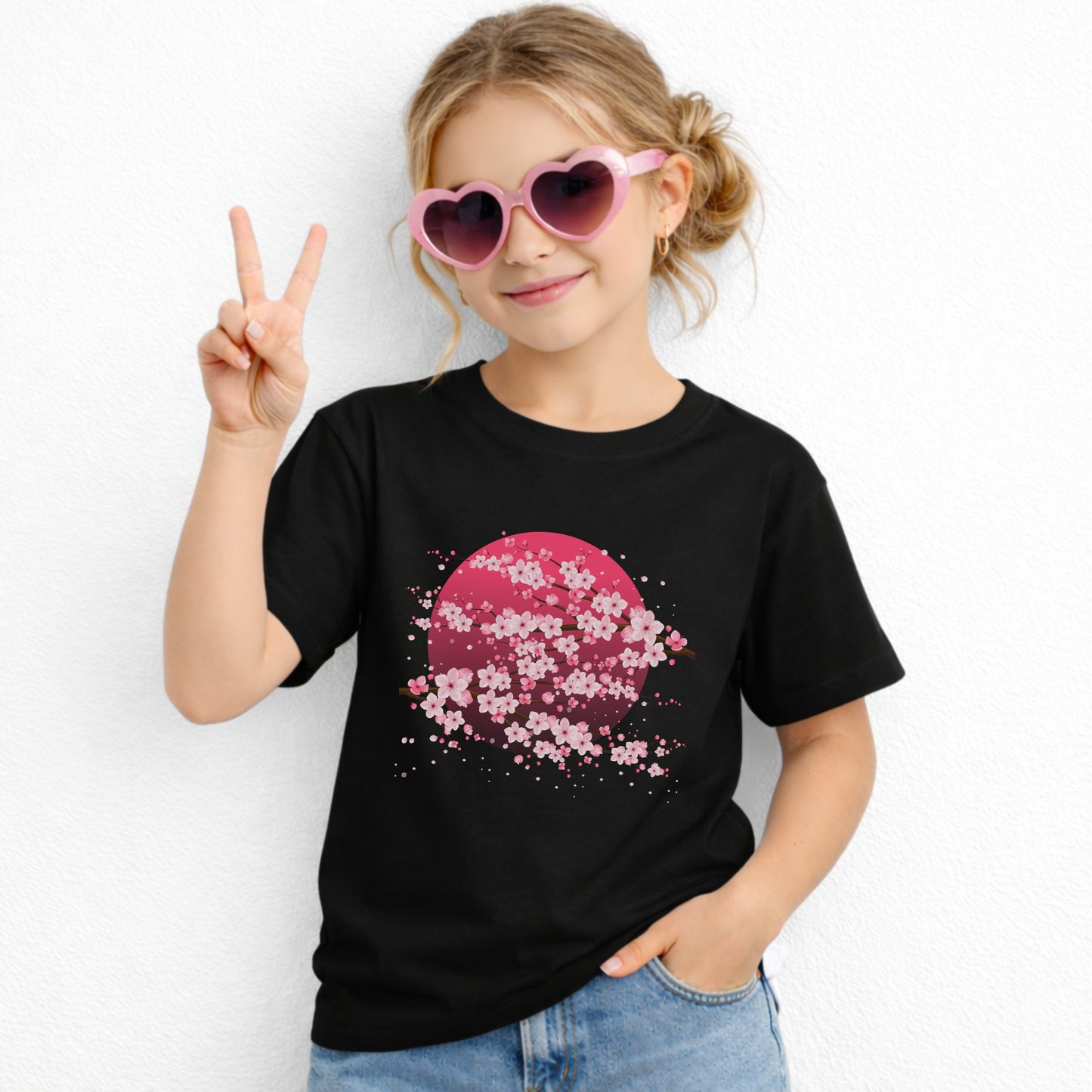 Kids cherry blossom t shirt featuring delicate pink sakura flowers and Japanese inspired artwork. This children's graphic tee has a soft feel and classic casual style that makes it easy to wear with jeans, shorts, skirts, or leggings.