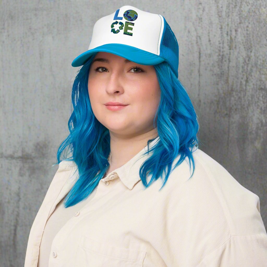 LOVE Earth Day Foam Trucker Hat, which features the letters L-O-V-E in large embroidered block letters in shades of blue and green. The hat is teal and white. The letters each represent water, earth, recycling and nature. by jaecrece.com