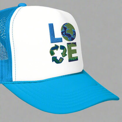 LOVE Earth Day Foam Trucker Hat, which features the letters L-O-V-E in large embroidered block letters in shades of blue and green. The hat is teal and white. The letters each represent water, earth, recycling and nature. by jaecrece.com