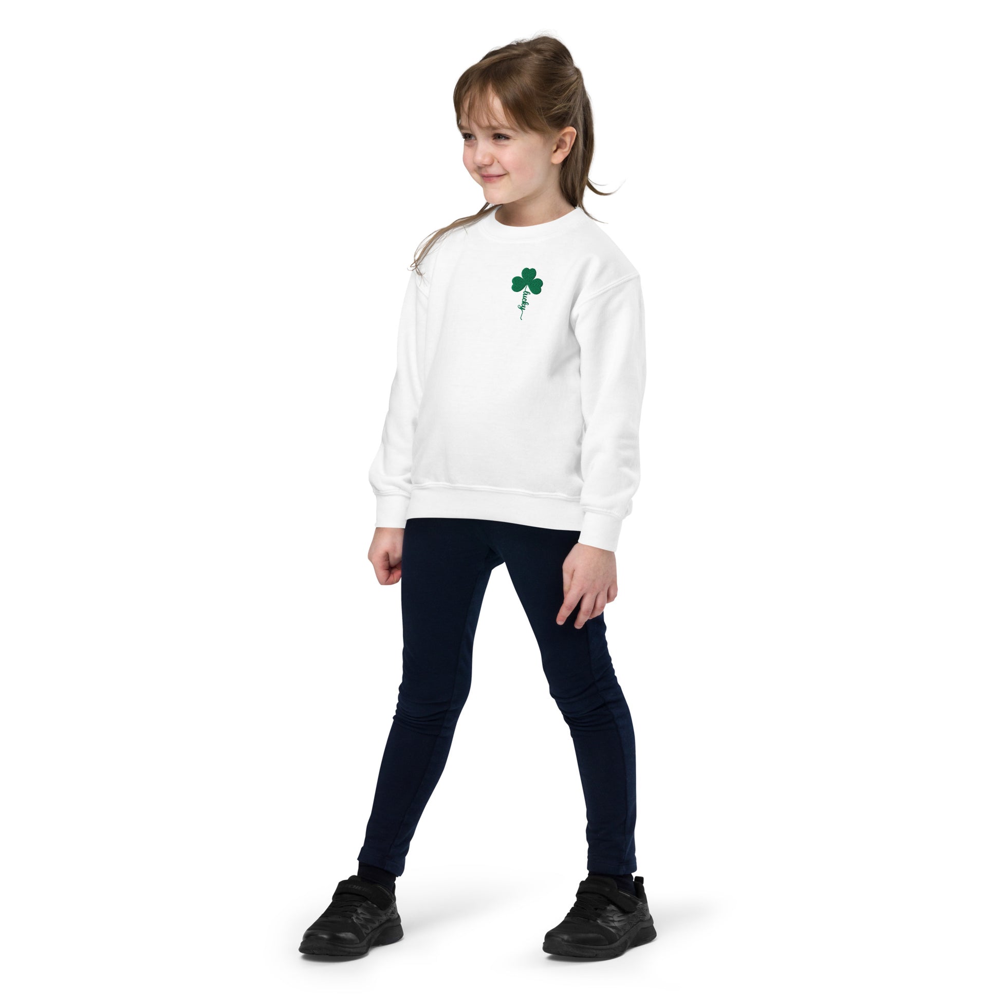 Four leaf clover lucky sweatshirt for kids featuring embroidered shamrock design stitched in green thread on a white youth crewneck sweatshirt. The clover stem spells the word “Lucky” in elegant script lettering, creating a festive St Patrick’s Day design. This comfortable Gildan 18000B youth sweatshirt has a soft fleece interior and relaxed fit, making it perfect for St Patrick’s Day school celebrations, festive parades, and family holiday photos. A charming lucky shamrock sweatshirt for kids celebrating S