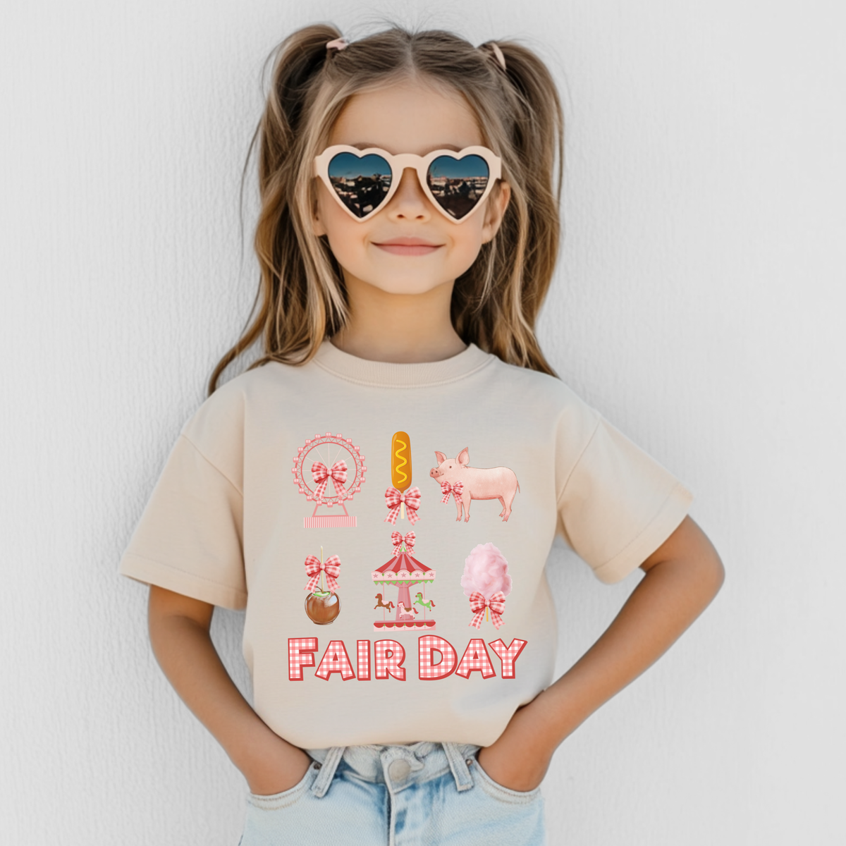 Natural girls fair outfit featuring a playful Fair Day graphic in pink, red, yellow and peach. The design includes a Ferris wheel, carousel, cotton candy, corn dog, caramel apple and pink pig with coordinating gingham bows.