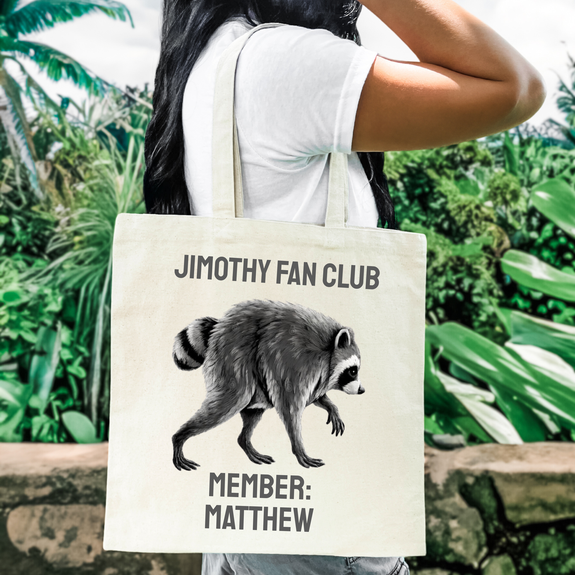 Personalized raccoon canvas tote featuring Jimothy Fan Club lettering and a custom member name printed beneath the illustrated raccoon. Funny Jimothy gift and personalized tote for viral raccoon fans, Seattle fans, animal lovers, and anyone who wants to join the Jimothy Fan Club.