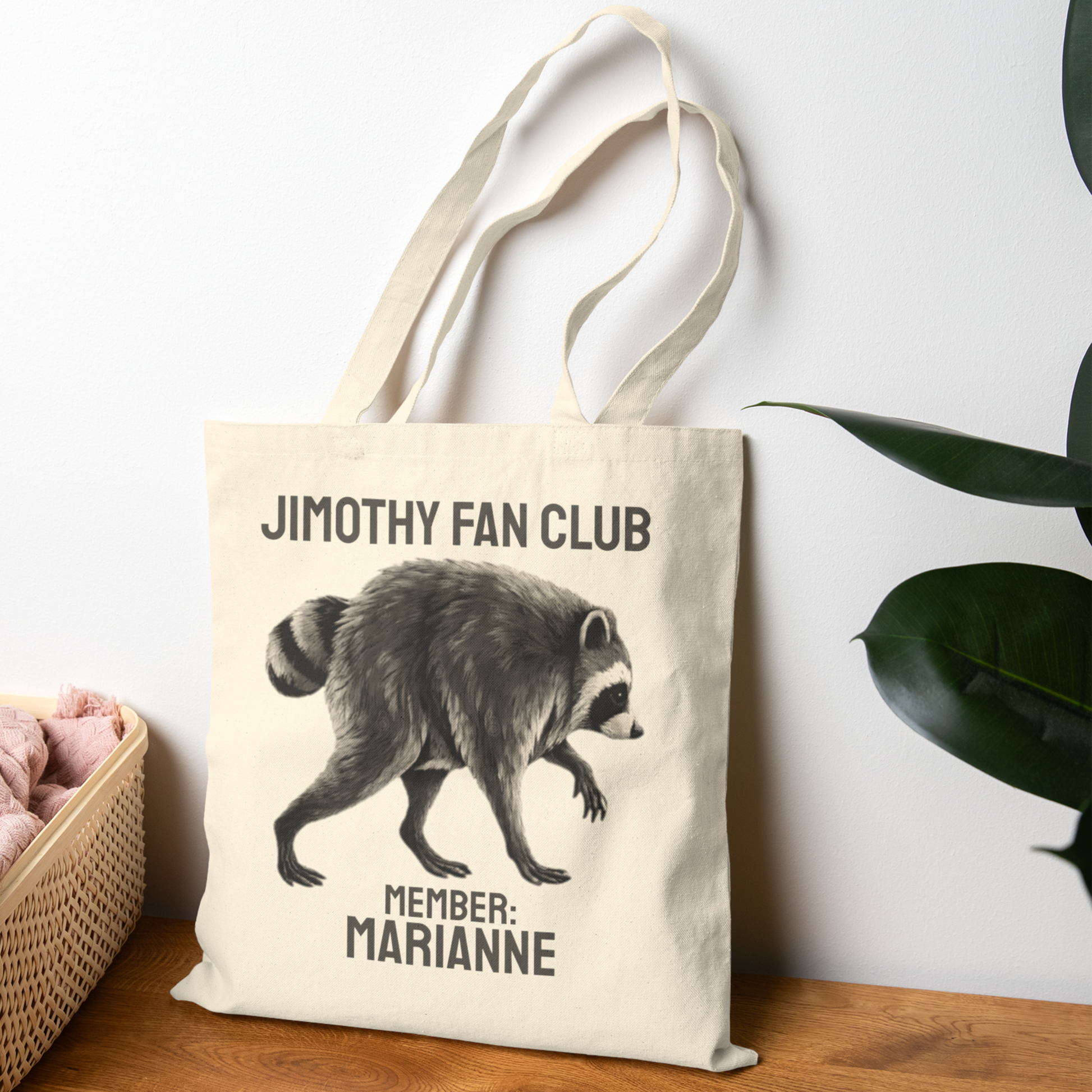 Personalized Jimothy Fan Club tote bag featuring a quirky raccoon illustration, vintage inspired lettering, and custom MEMBER name personalization on a natural cotton canvas tote. Funny Jimothy raccoon gift for Seattle fans, raccoon lovers, animal lovers, and meme fans.