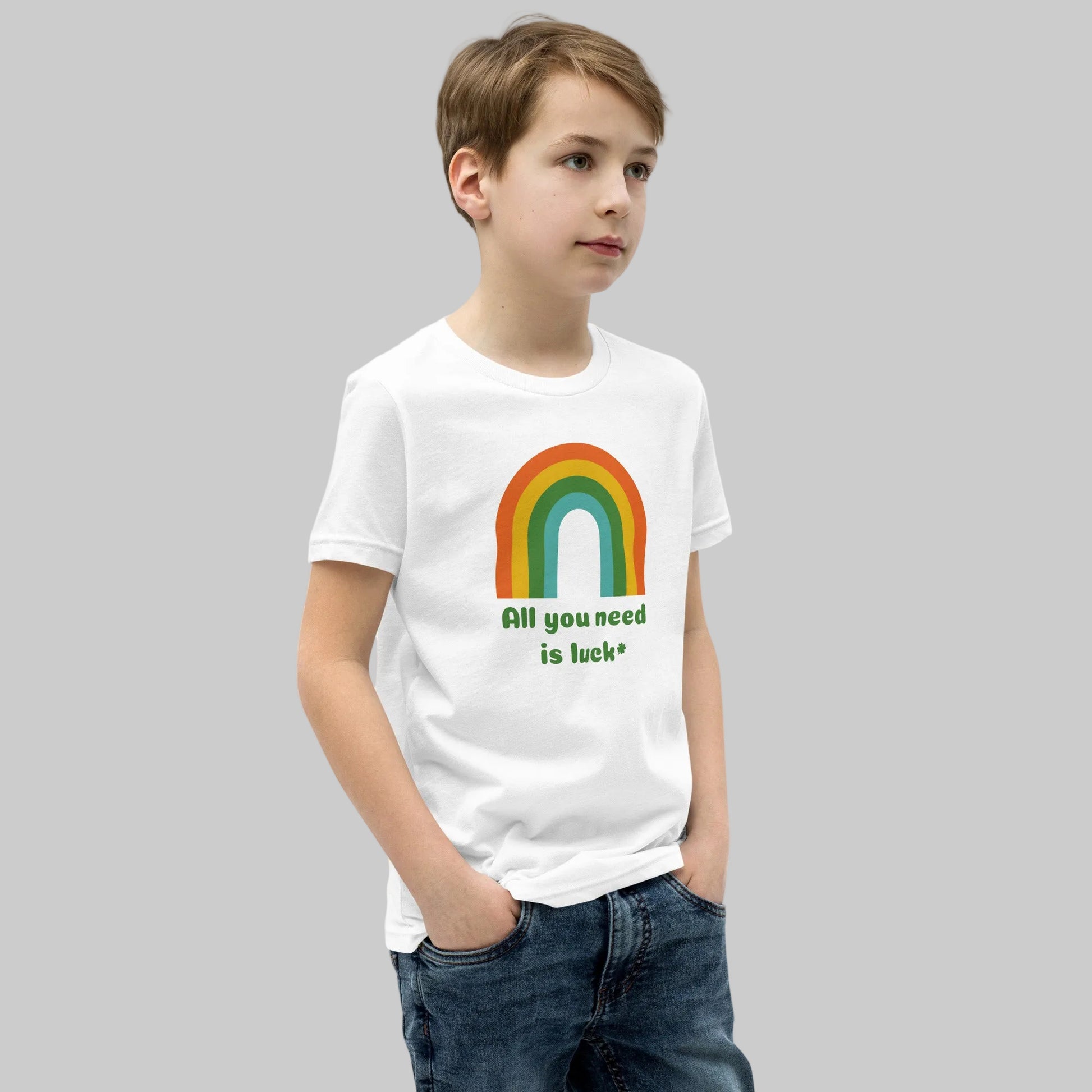 Youth St Patricks Day shirt with All You Need Is Luck phrase and lucky shamrock clover graphic printed on a soft Bella Canvas 3001Y kids t shirt. Comfortable festive holiday clothing for children celebrating St Patrick's Day with family and friends.