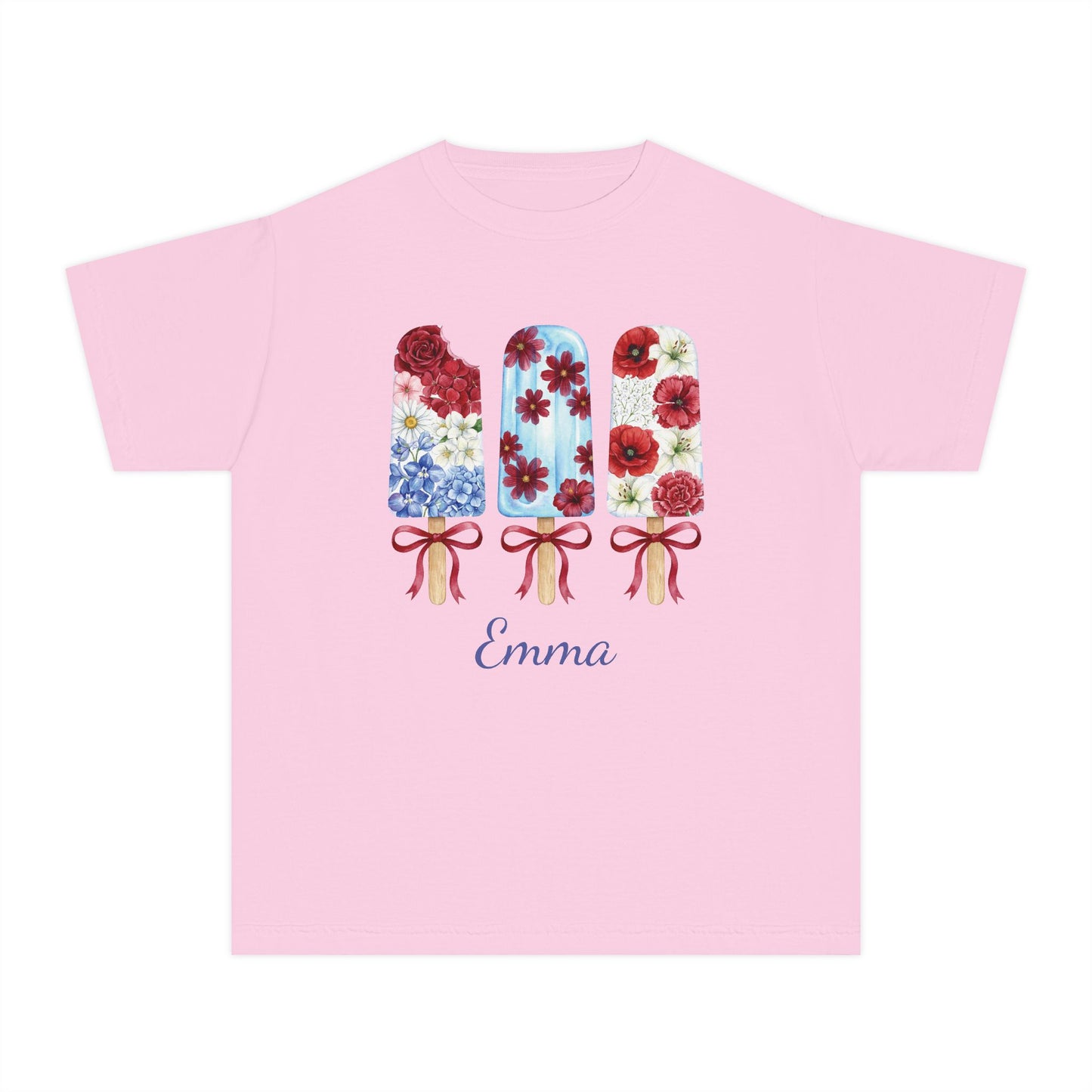 A light pink short sleeve t-shirt with a graphic of three decorated popsicles and the name 'Emma' printed below in blue cursive, displayed on a solid white background.
