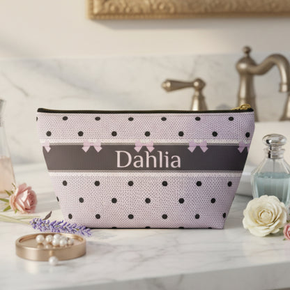 Lavender and black makeup bag with a romantic dark romance design featuring bows, polka dots, delicate lace inspired details and personalized lettering. This canvas zipper pouch makes a beautiful travel accessory for cosmetics, skincare and toiletries while bringing a gothic coquette aesthetic to your everyday routine.