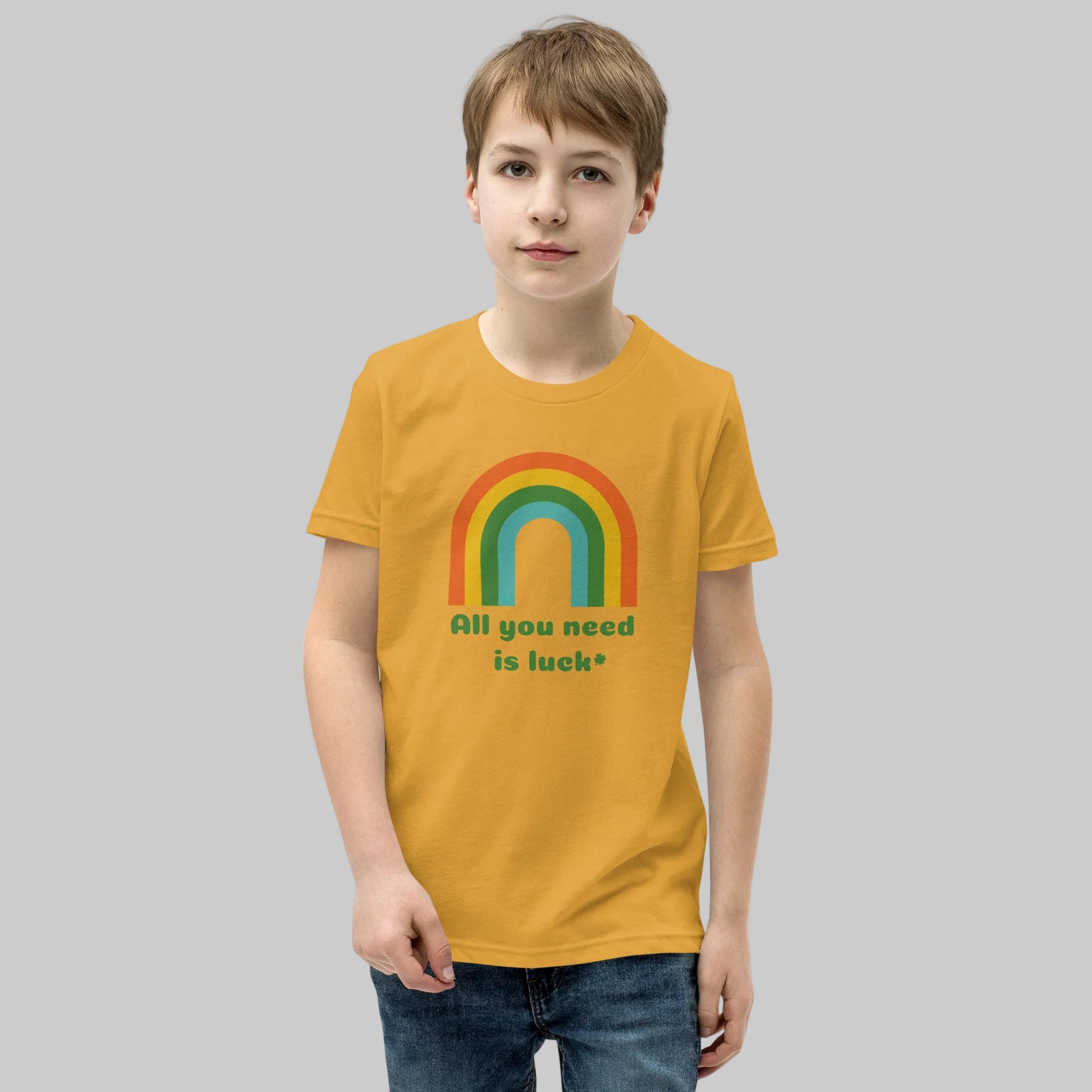  All You Need Is Luck shamrock rainbow and clover graphic printed on Bella Canvas 3001Y youth t shirt. Lucky St Patricks Day design featuring festive Irish themed artwork perfect for kids holiday clothing and March celebrations.