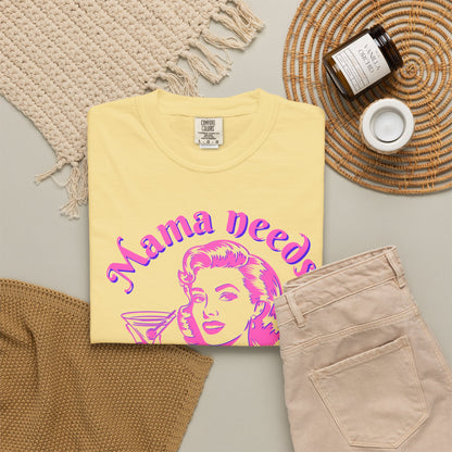 Image: A playful and stylish Mama Needs a Mocktail tshirt featuring a bright pink neon graphic of a pop art vintage mom enjoying a drink. This Comfort Colors tee, available in six color options, is a fantastic way to celebrate pregnancy, sobriety, or the choice to go alcohol free. Whether worn at a baby shower or a mocktail happy hour, this shirt brings humor and positivity to any setting.