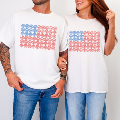 Man and woman wearing matching smiley face American flag shirts, unisex patriotic graphic tees perfect for couples, family 4th of July outfits, fireworks celebrations, and summer gatherings