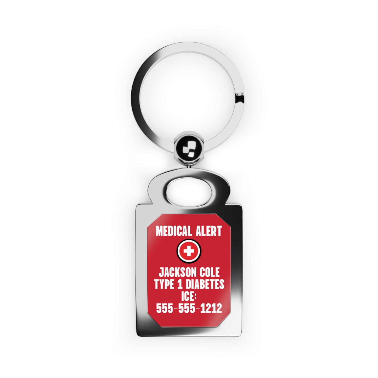 A medical alert keychain with a polished silver metal split ring and a rectangular tag featuring a red background with white text and a white cross symbol. The tag reads 'MEDICAL ALERT', 'JACKSON COLE TYPE 1 DIABETES', 'ICE:', and '555-555-1212'.