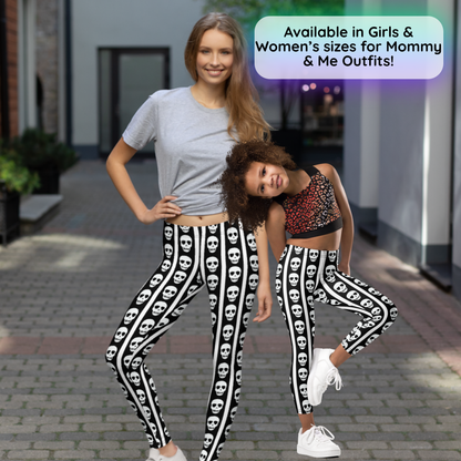 Two models, an adult woman and a young girl, wearing matching black and white skull patterned leggings, posing outdoors on a paved walkway. A text overlay in the top right reads 'Available in Girls & Women's sizes for Mommy & Me Outfits!'.