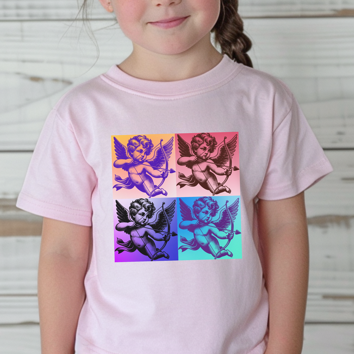 Featuring a fun, artsy Cupid graphic, this Pop Art Toddler T-shirt in sizes 2T-5T is perfect for toddlers who love playful, retro-inspired fashion. Available in classic Black, White, and Pink, the t-shirt is made with soft fabric to keep kids comfortable and stylish all day. This bold, vintage Cupid design is great for casual outings, themed family outfits, or celebrating Valentine’s Day with a pop culture twist.