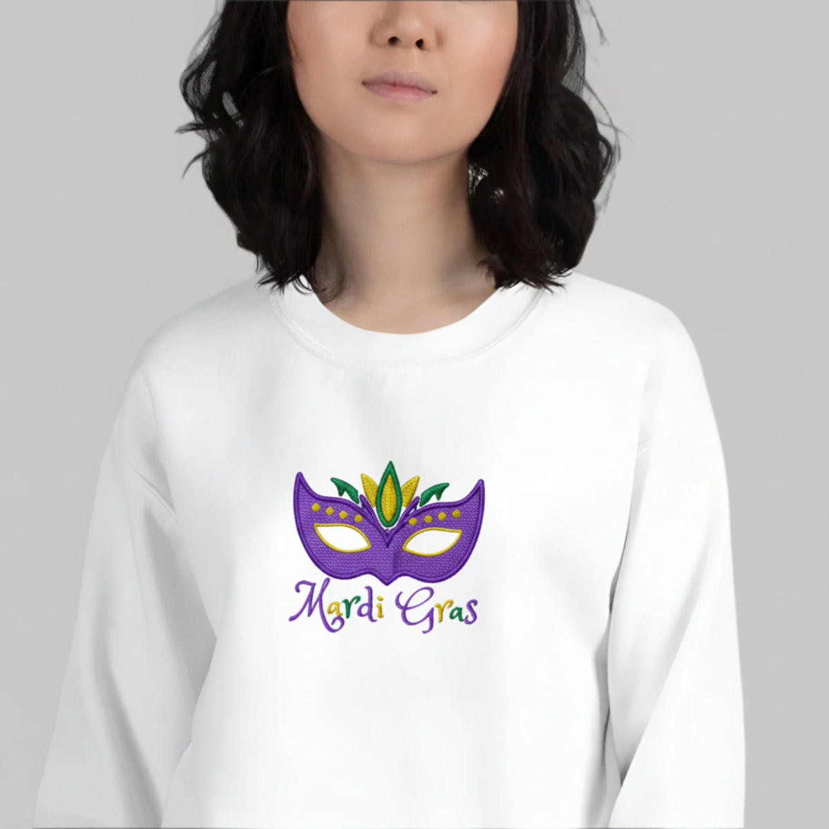 Celebrate Carnival in comfort and color with this Mardi Gras embroidered sweatshirt for adults. The design includes a bold mask in purple, green, and gold and “Mardi Gras” stitched across the front—ideal for matching family looks at French Quarter parades, New Orleans celebrations, or festive costume events. Available in inclusive unisex sizing from S to 5XL.