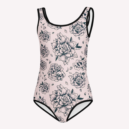 A one piece swimsuit with a light pink background and a black floral pattern, featuring black trim along the neckline, arm straps, and leg openings.