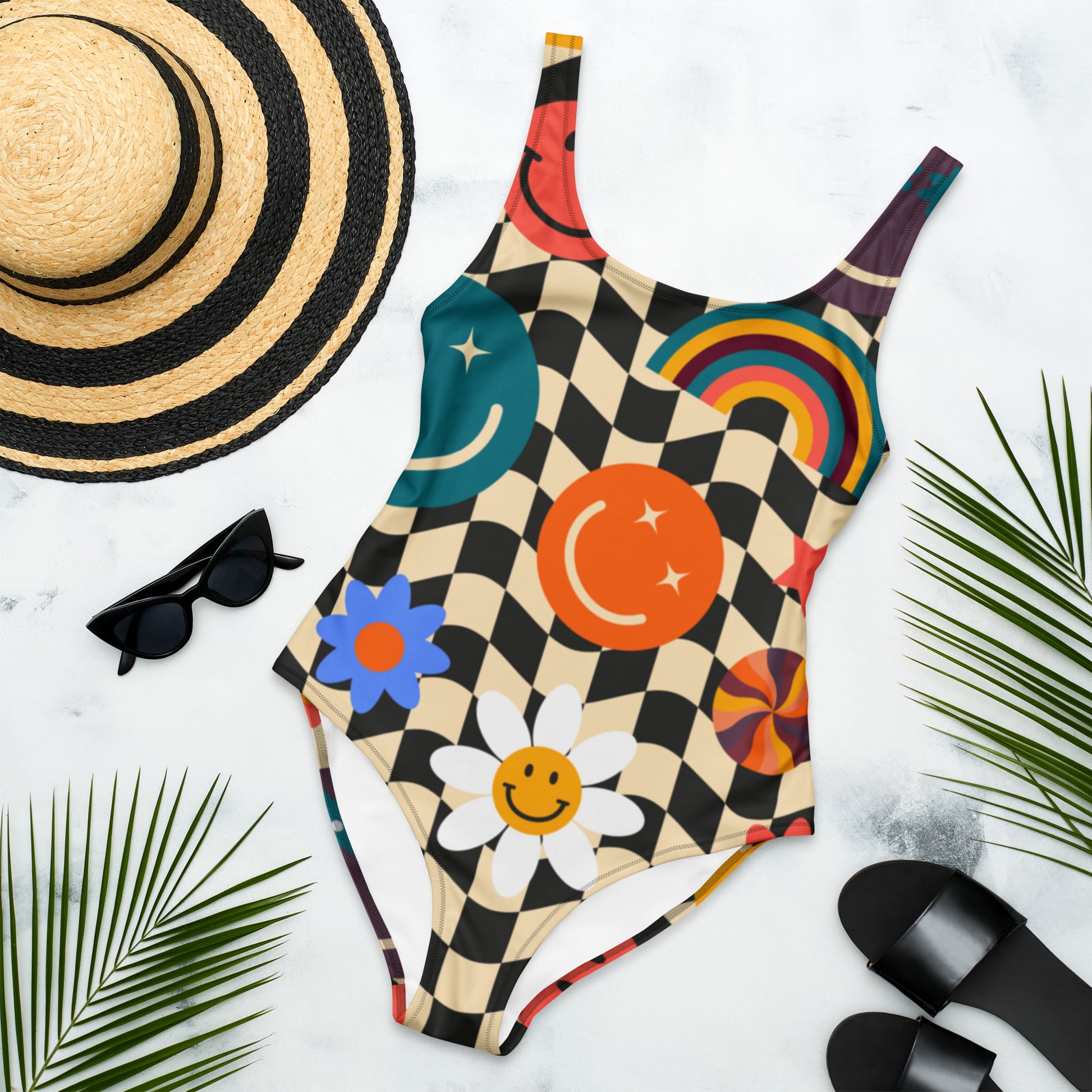 Women’s one piece swimsuit featuring a retro wavy checkerboard pattern with colorful smiley faces, rainbows, daisies, stars, and swirls. This playful scoop back swimsuit is part of a matching family swimwear collection with coordinating girls swimsuits, rash guards, and men’s swim trunks.