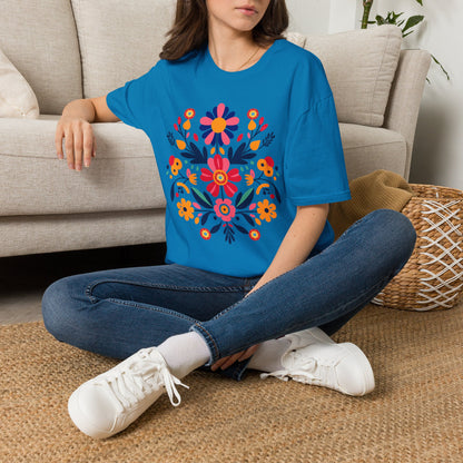 Colorful Otomi folk art shirt featuring a vibrant floral design inspired by traditional Mexican folk art. The bright graphic combines colorful flowers and folk art elements on a classic Gildan 64000 Softstyle tee, creating a cheerful Mexican inspired shirt that works for everyday outfits, cultural celebrations, Hispanic Heritage Month, family gatherings, and anyone who loves colorful folk art clothing.