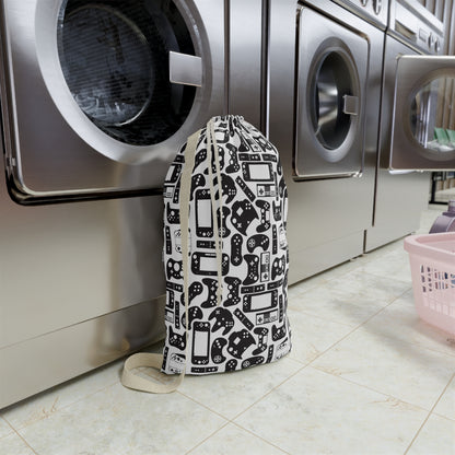 Laundry bag with gaming console pattern in front of a washing machine in a laundry room.