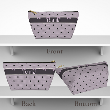 Personalized toiletry bag for women and girls featuring a lavender and black gothic coquette design with bows, polka dots and lace inspired details. The canvas zipper pouch is customized with a name or initials and provides space for makeup, skincare and personal essentials. A feminine travel accessory and thoughtful gift for tweens or teens.