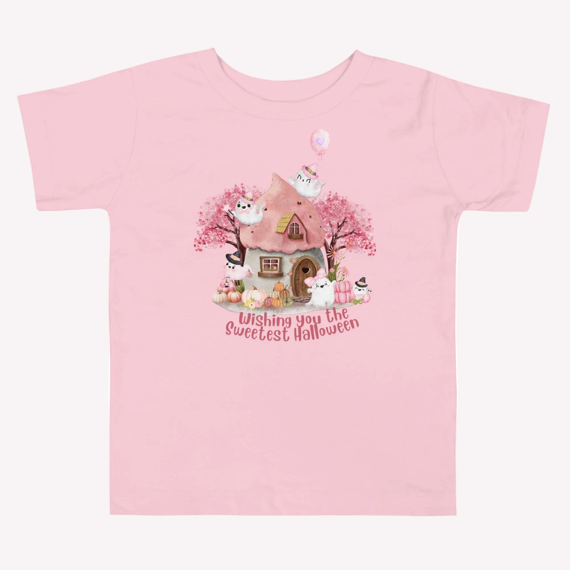 Pink Halloween toddler shirt with smiling and playful ghosts, pastel pumpkins, flowers, autumn trees, and a charming haunted cottage. The phrase Wishing You the Sweetest Halloween is featured in large pink lettering for a cheerful and whimsical Halloween look.