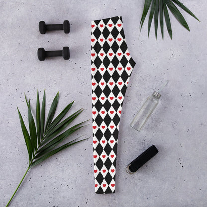 Women's black and white harlequin leggings decorated with red hearts create a playful Valentine's Day outfit. The bold pattern adds personality to a simple red, pink, black, or white top and can be dressed up or down. These heart print leggings are also versatile enough to wear beyond Valentine's Day for casual outfits, festivals, parties, or themed events.
