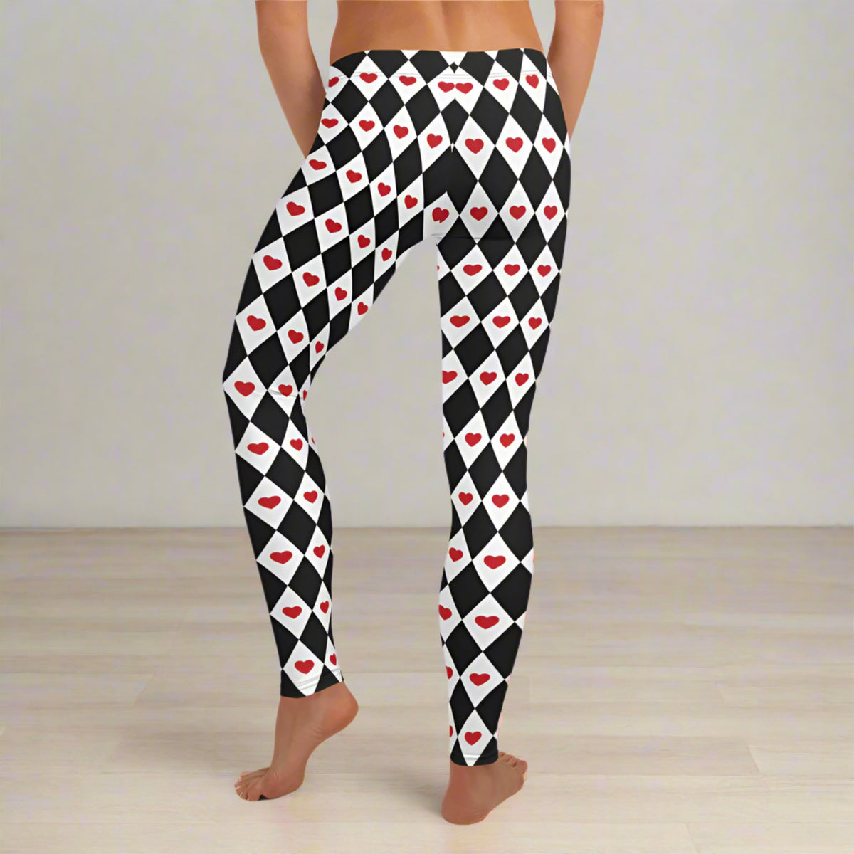 Harlequin Love pattern showing black and white diamonds paired with vivid red hearts. The combination creates a playful retro look with a whimsical theatrical feel. These women's heart print leggings are easy to style with black, white, red, or pink tops for Valentine's Day, everyday outfits, or a creative themed costume.
