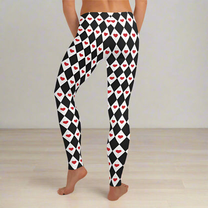 Harlequin Love pattern showing black and white diamonds paired with vivid red hearts. The combination creates a playful retro look with a whimsical theatrical feel. These women's heart print leggings are easy to style with black, white, red, or pink tops for Valentine's Day, everyday outfits, or a creative themed costume.