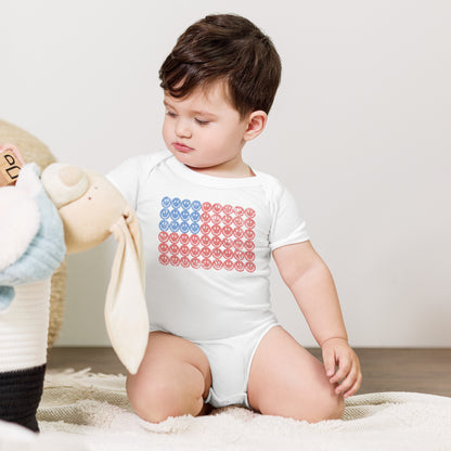 White short sleeve baby onesie with a playful retro American flag design made of smiley faces in red and blue tones. Designed for patriotic baby outfits, 4th of July celebrations, and summer holiday photos. Soft breathable cotton makes it perfect for newborns and infants. Great gift for baby showers, Independence Day outfits, and America 250 themed patriotic family matching.